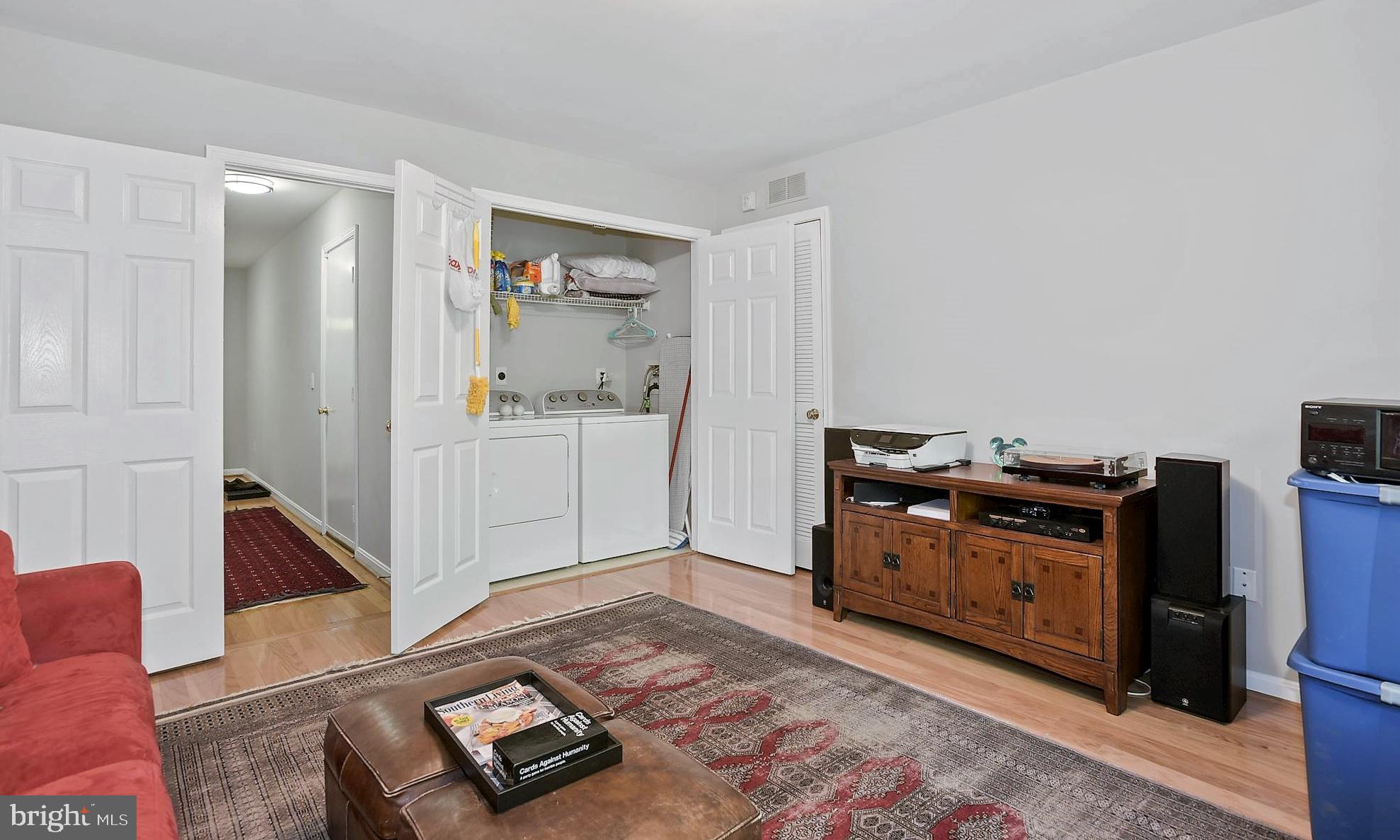 12062 Edgemere Circle Reston, VA 20190 - Photo 21 of 29 a living room with a bed furniture and a wooden floor