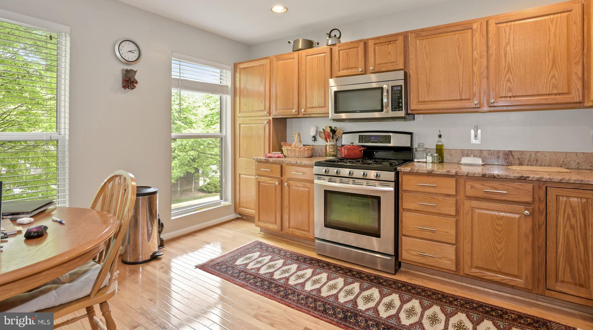 12062 Edgemere Circle Reston, VA 20190 - Photo 3 of 29 a kitchen with stainless steel appliances a stove a sink and a microwave