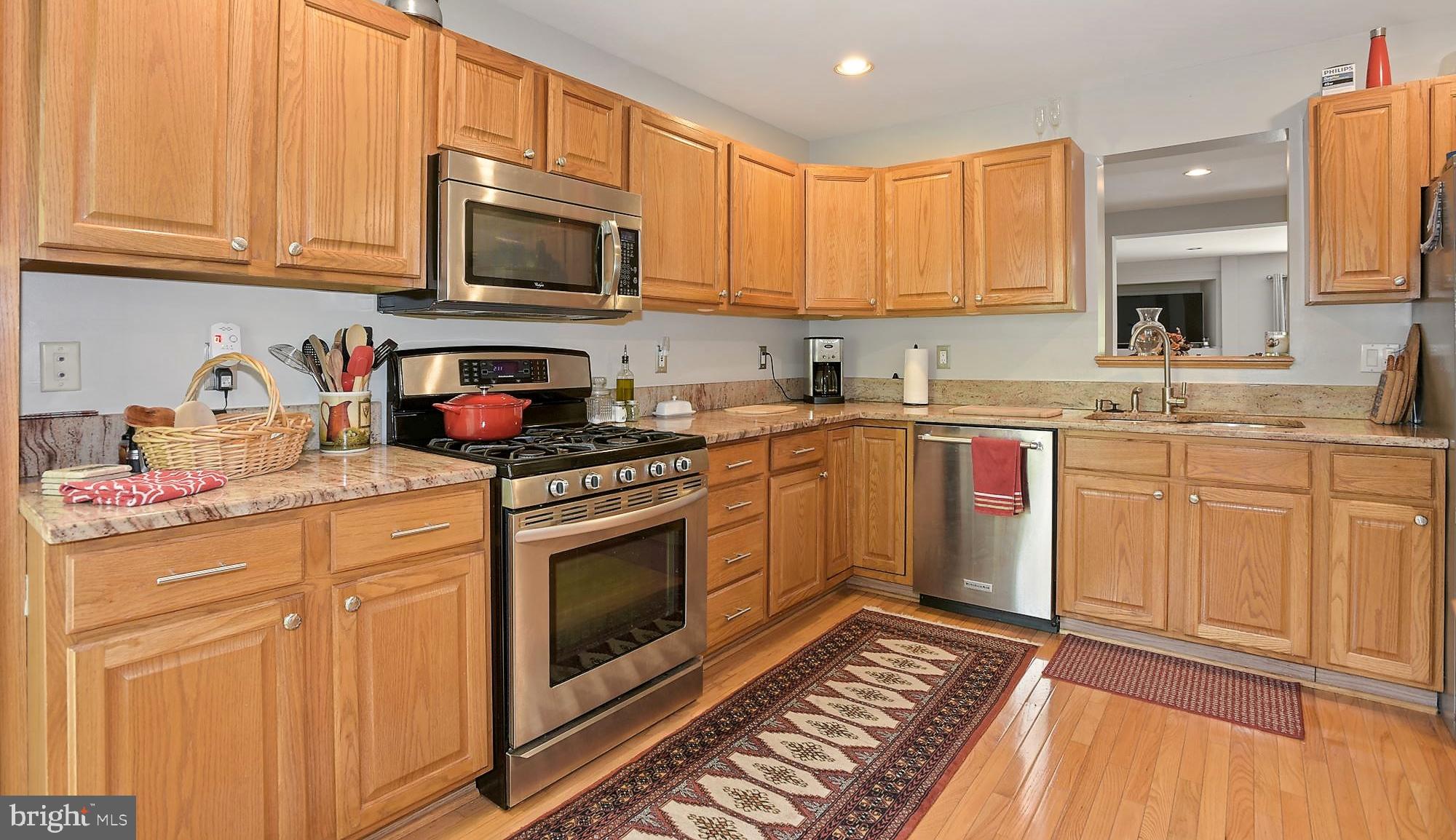 12062 Edgemere Circle Reston, VA 20190 - Photo 4 of 29 a kitchen with stainless steel appliances granite countertop a sink stove and cabinets