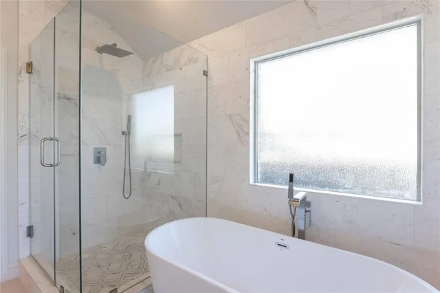 a bathroom with a granite countertop sink a toilet a tub and shower