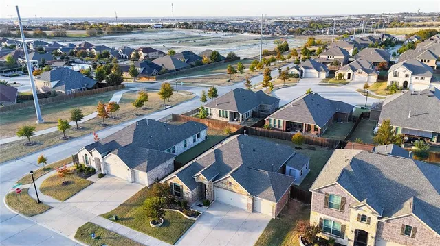 an aerial view of residential houses with outdoor space