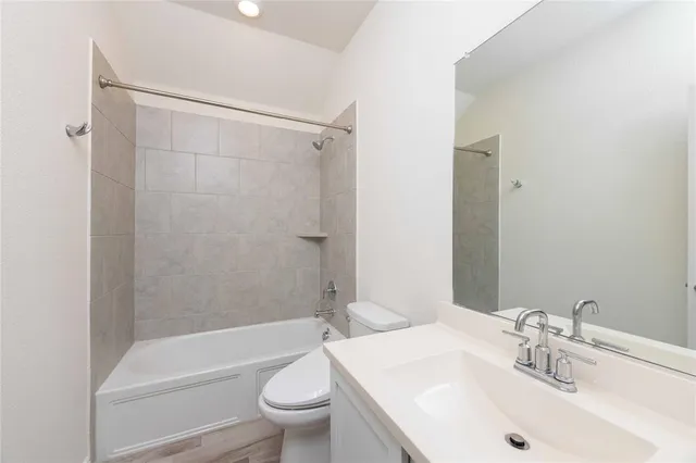 a bathroom with a sink a toilet and bathtub