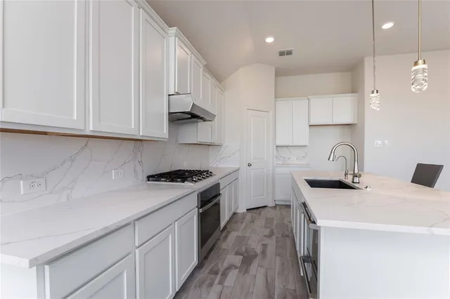 an empty room with windows and a fireplace