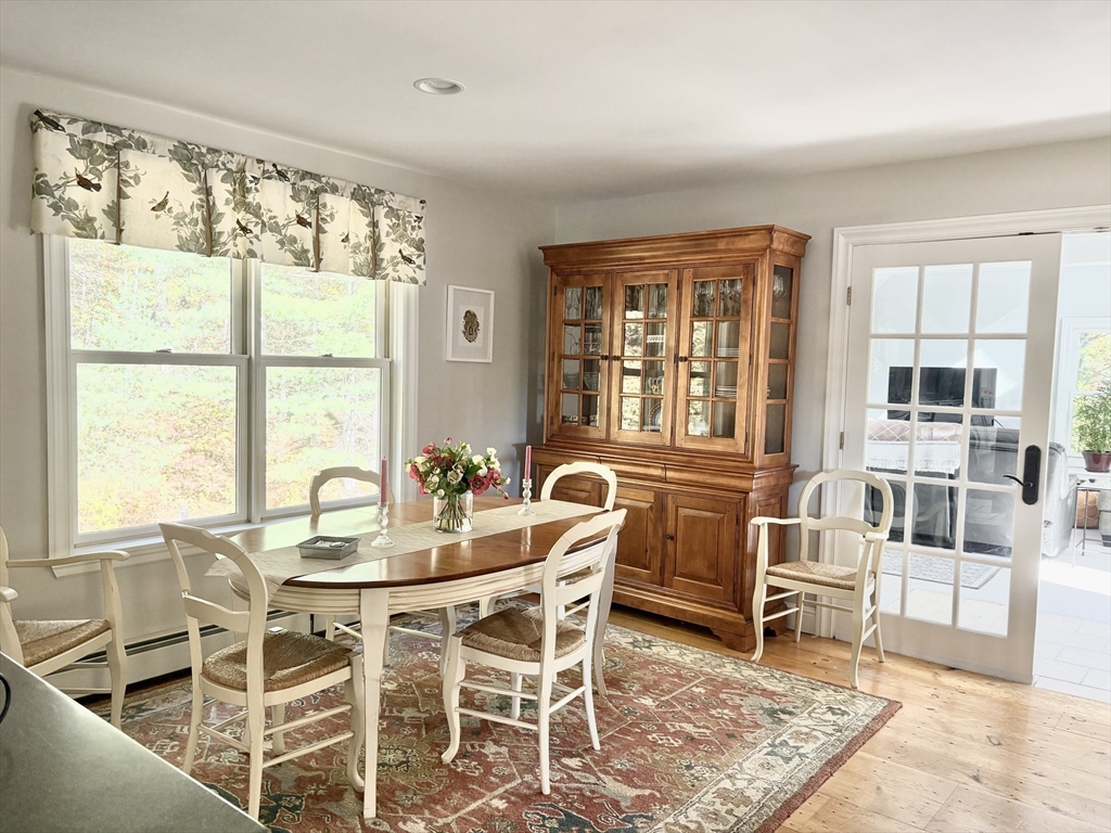 101 Russell Hill Road Ashburnham, MA 01430 - Photo 14 of 42 a dining room with wooden floor and large windows
