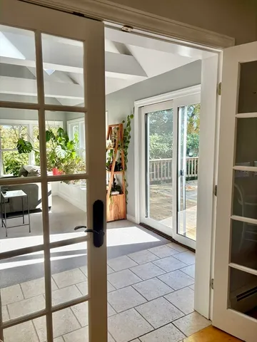 a view of empty room with wooden floor and floor to ceiling window