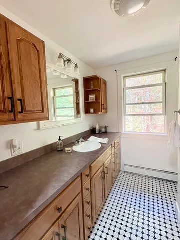 a bathroom with a sink a vanity and a window