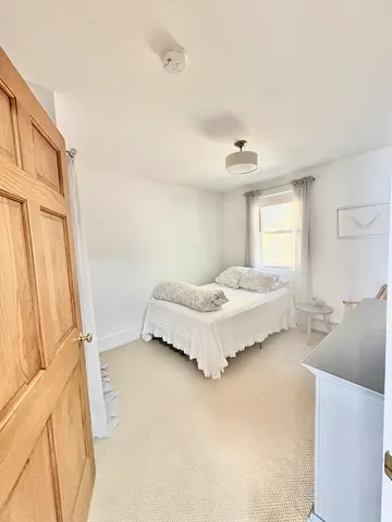 a spacious bedroom with a bed and a cabinets