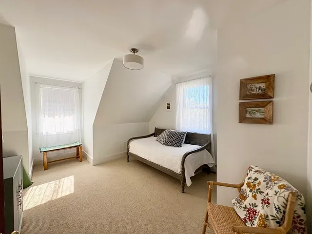 a bedroom with furniture and a window
