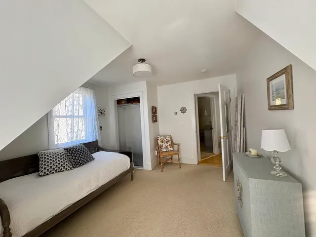 a bedroom with bed and window