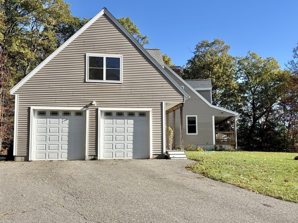 101 Russell Hill Road Ashburnham, MA 01430 - Photo 4 of 42 a front view of house with yard and trees in the background