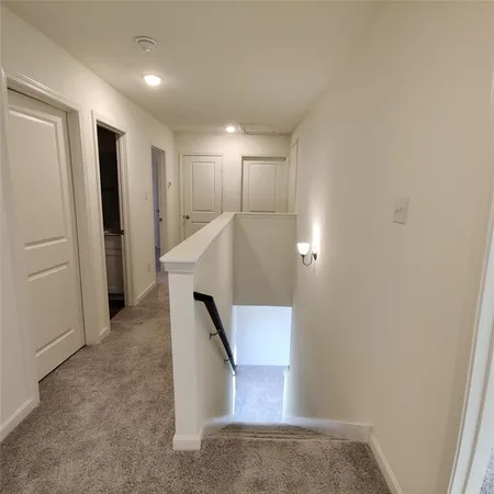 an entryway in a hall with wooden floor