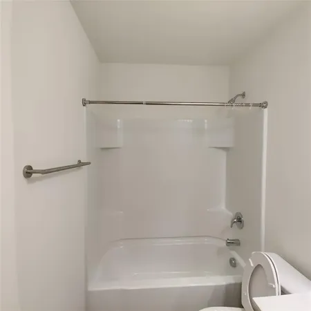 a bathroom with a shower and a bath tub