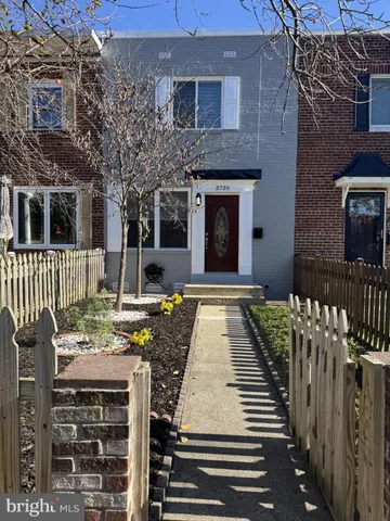 a view of a patio with couches table and chairs and potted plants