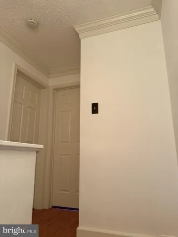 a bedroom with a bed and a night stand