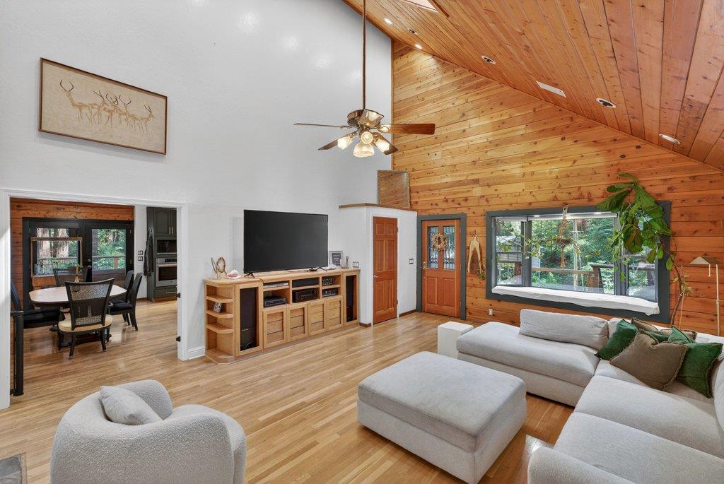 360 McGaffigan Mill Road Boulder Creek, CA 95006 - Photo 17 of 70 a living room with furniture and a flat screen tv