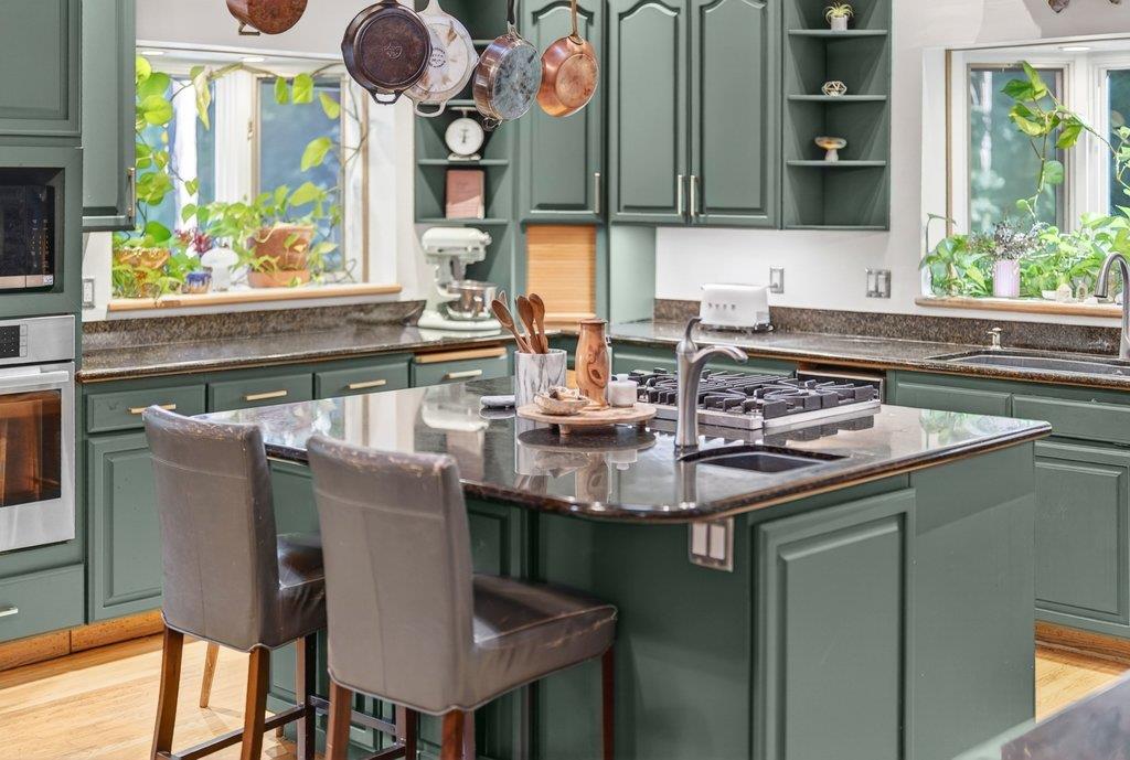360 McGaffigan Mill Road Boulder Creek, CA 95006 - Photo 23 of 70 a kitchen with a sink and a stove with wooden floor