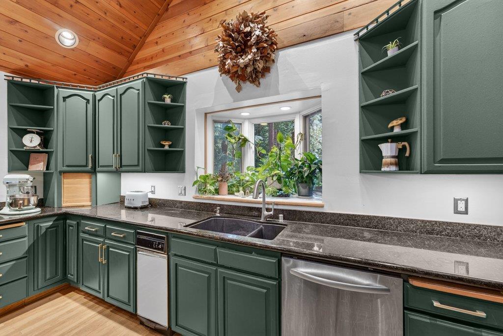 360 McGaffigan Mill Road Boulder Creek, CA 95006 - Photo 26 of 70 a kitchen with stainless steel appliances granite countertop a sink a stove and a wooden cabinets