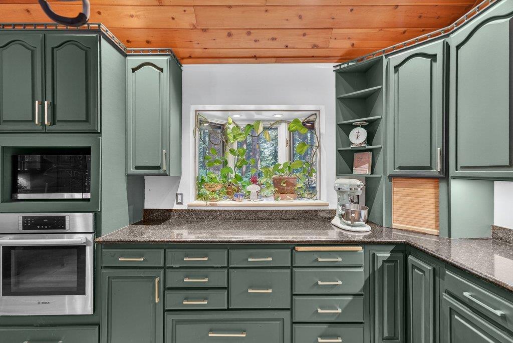 360 McGaffigan Mill Road Boulder Creek, CA 95006 - Photo 27 of 70 a kitchen with stainless steel appliances granite countertop a sink and a microwave