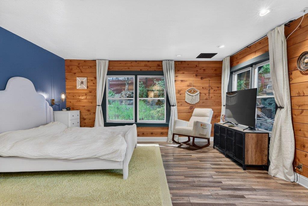 360 McGaffigan Mill Road Boulder Creek, CA 95006 - Photo 36 of 70 a bedroom with furniture and a flat screen tv