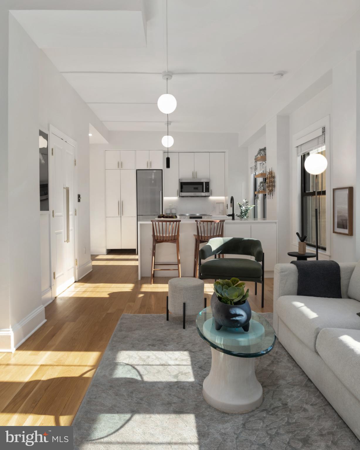 1613 Harvard Street Northwest, Unit 102 Washington, DC 20009 - Photo 17 of 27 a living room with furniture and a chandelier