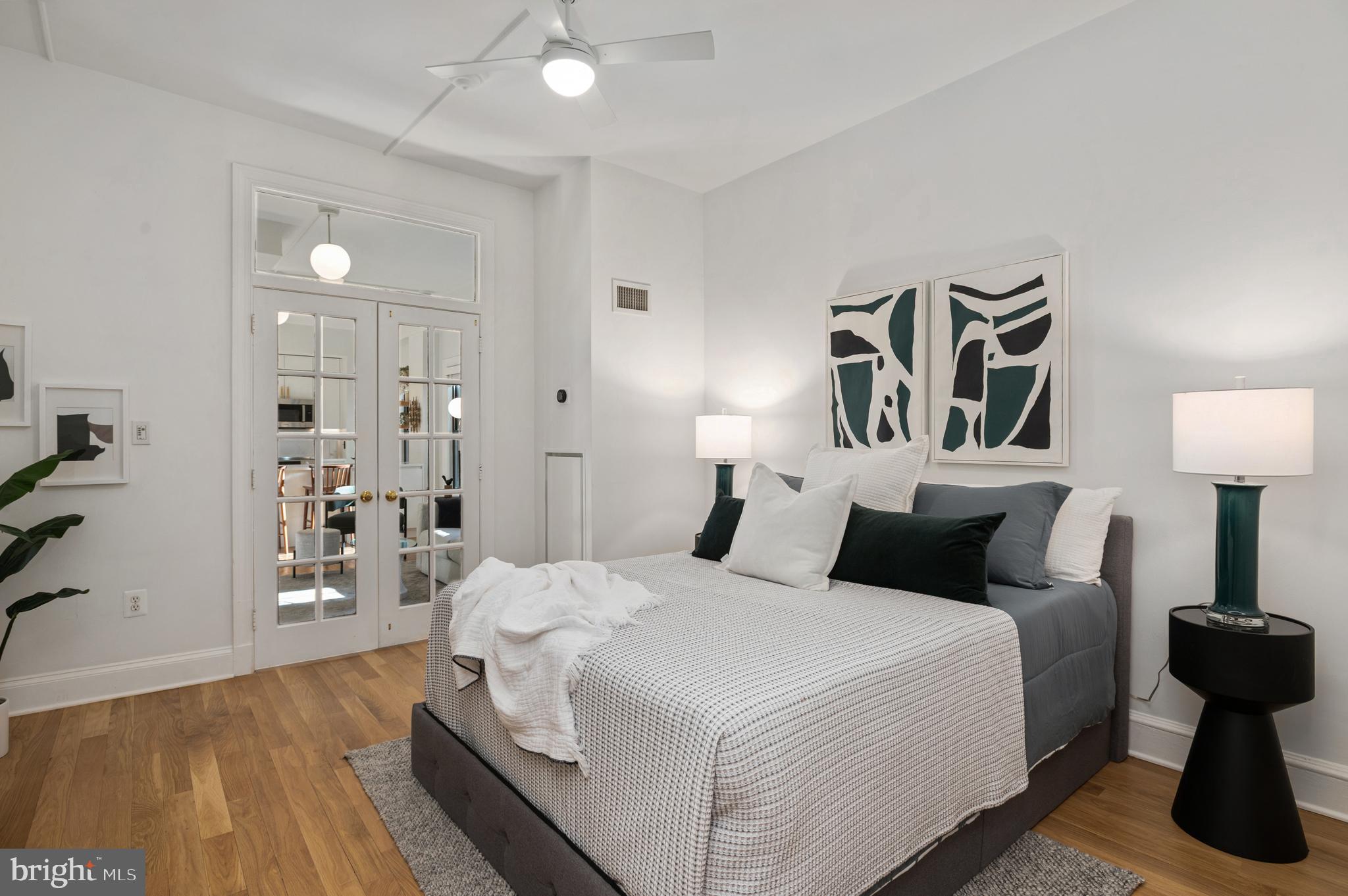 1613 Harvard Street Northwest, Unit 102 Washington, DC 20009 - Photo 19 of 27 a bedroom with a bed and wooden floor