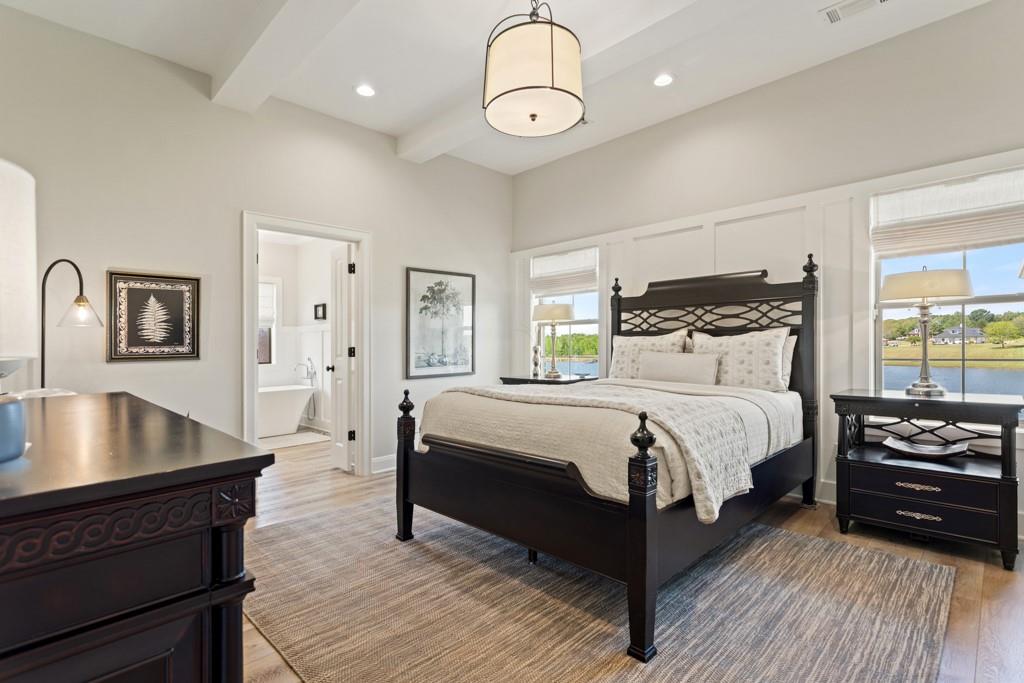 23630 Champion Drive Lindale, TX 75771 - Photo 24 of 36 a bedroom with a bed and dresser with wooden floor