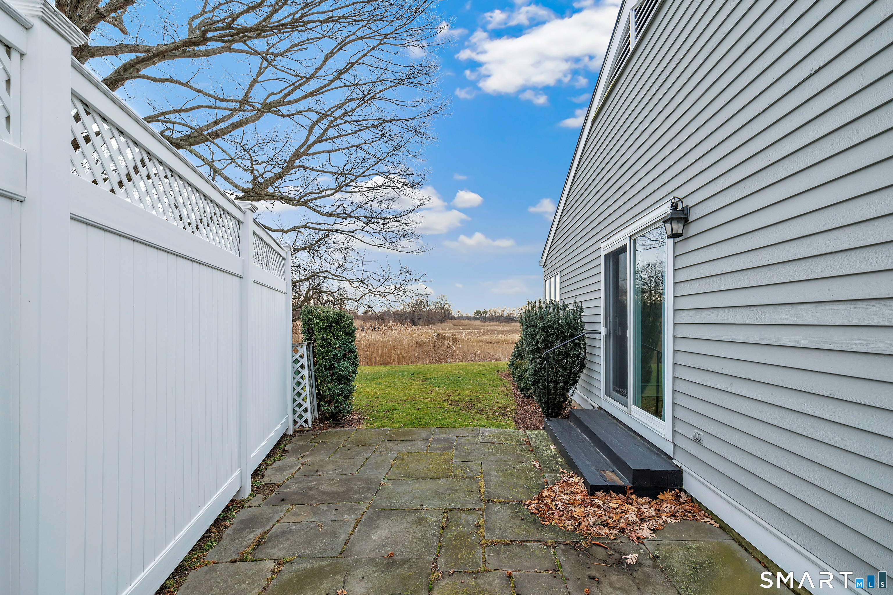 139 Field Point Drive, Unit 139 Fairfield, CT 06824 - Photo 11 of 34 a view of a backyard with sitting area