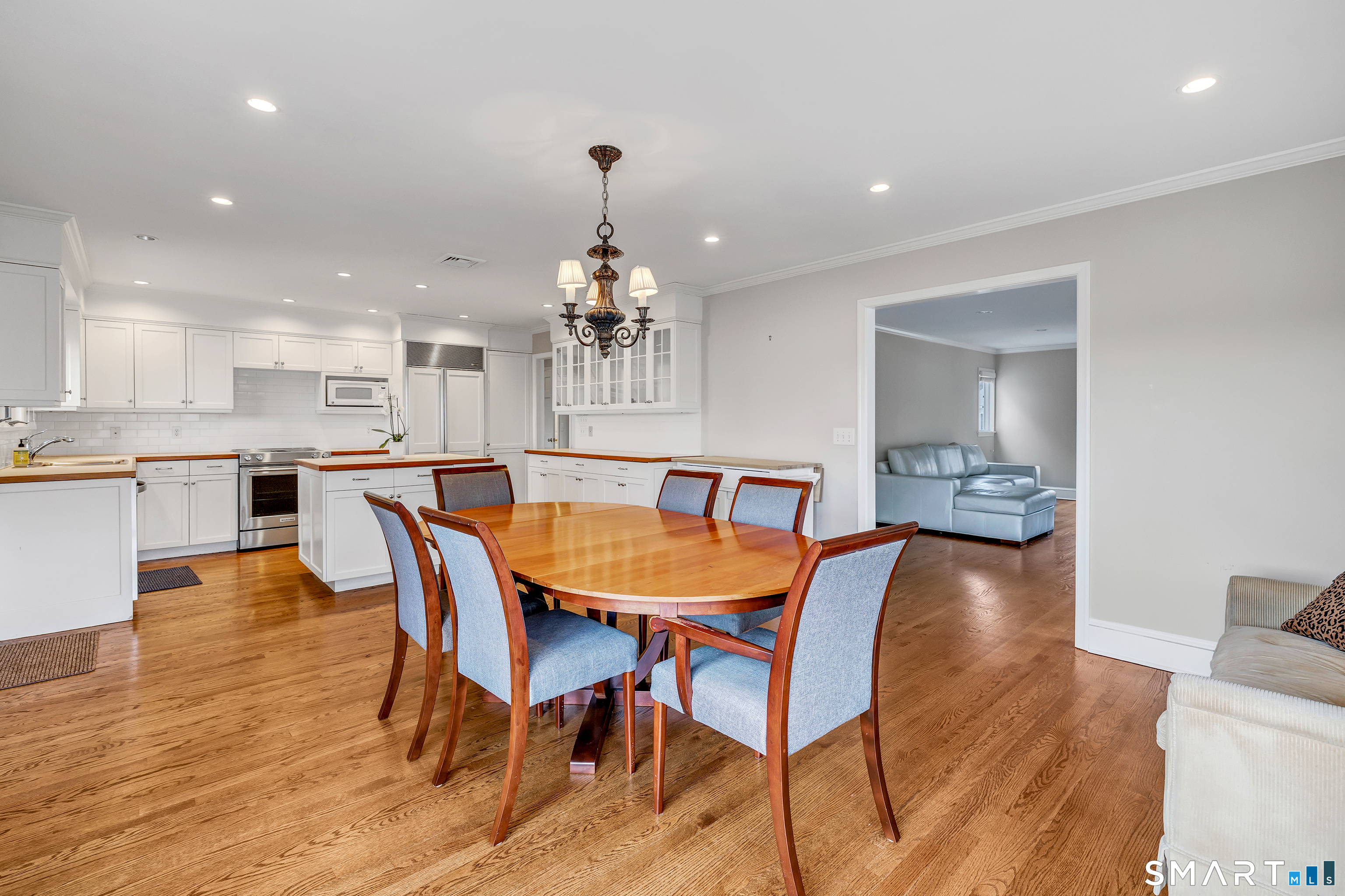 139 Field Point Drive, Unit 139 Fairfield, CT 06824 - Photo 13 of 34 a view of a dining room with furniture and wooden floor