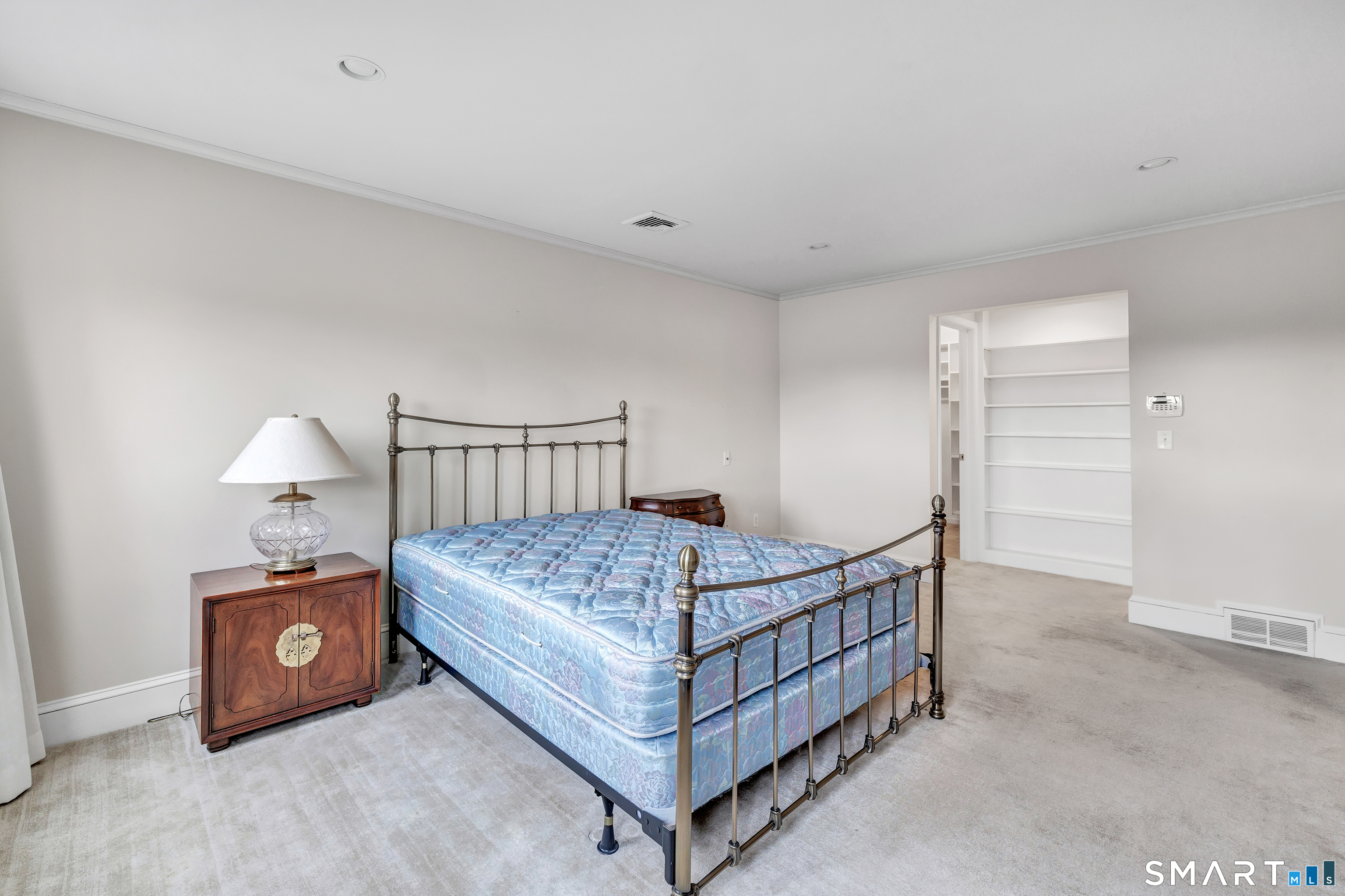 139 Field Point Drive, Unit 139 Fairfield, CT 06824 - Photo 20 of 34 a bedroom with a bed and a table