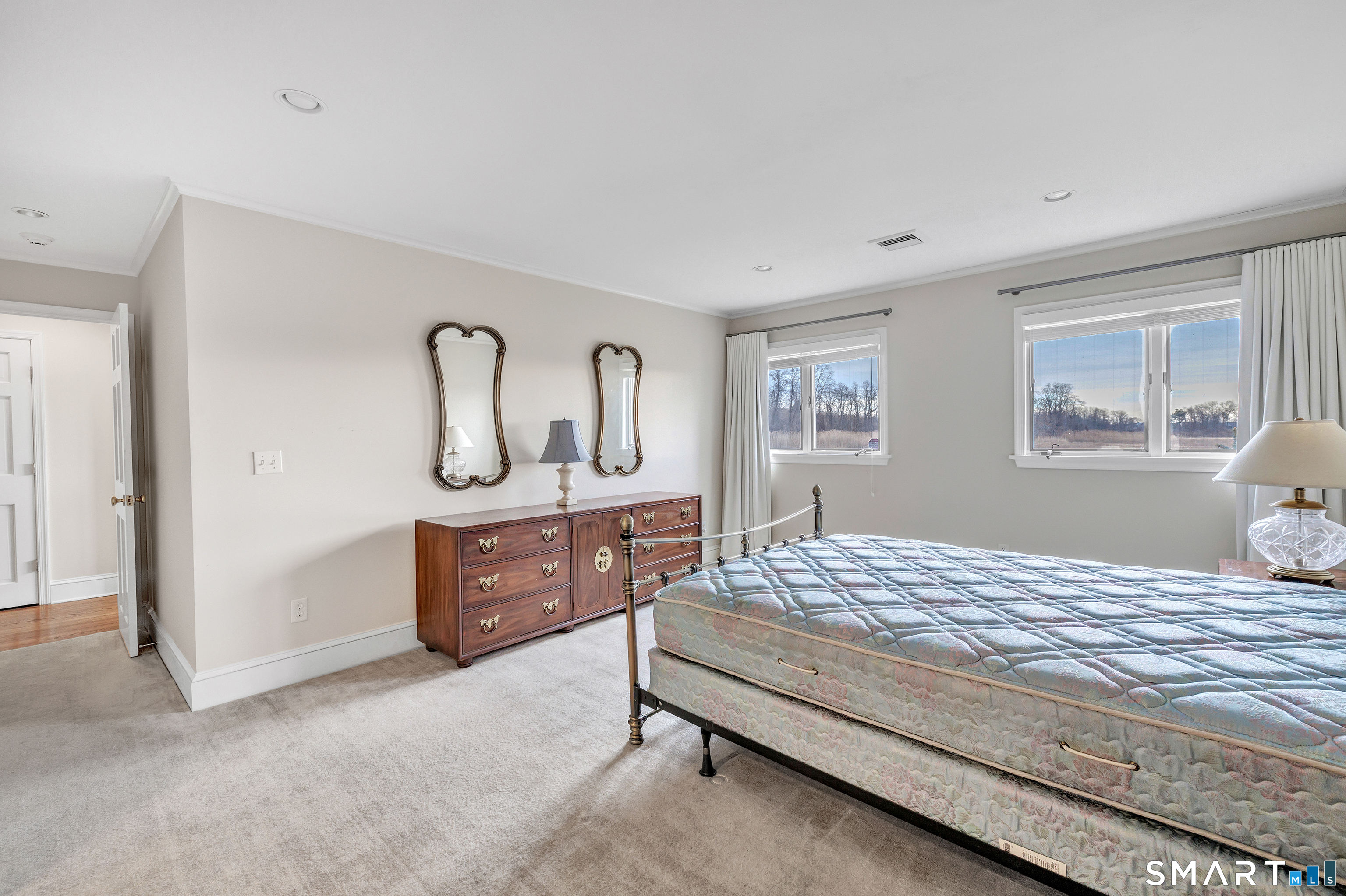 139 Field Point Drive, Unit 139 Fairfield, CT 06824 - Photo 21 of 34 a bedroom with a large bed and dresser