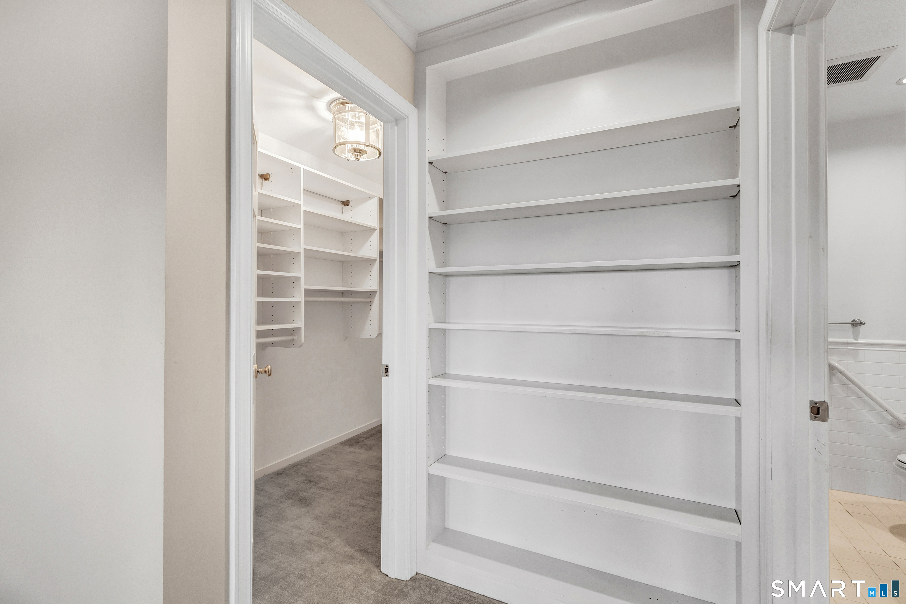 139 Field Point Drive, Unit 139 Fairfield, CT 06824 - Photo 22 of 34 a view of walk in closet with empty racks