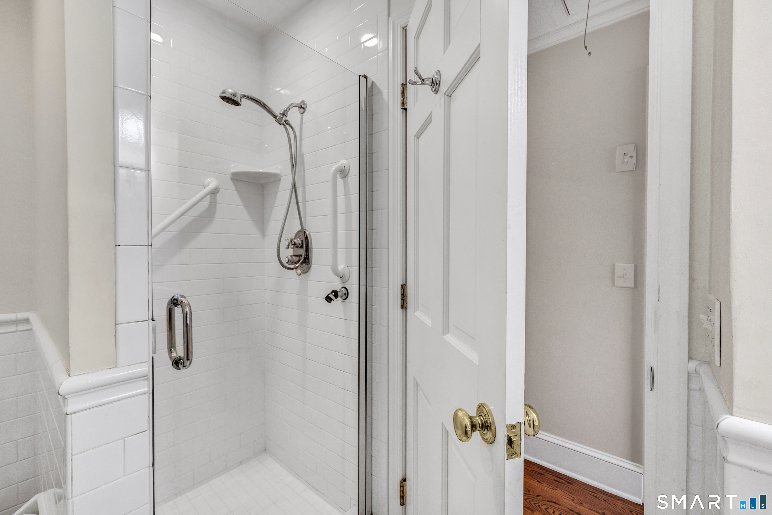 139 Field Point Drive, Unit 139 Fairfield, CT 06824 - Photo 27 of 34 a bathroom with a glass shower door