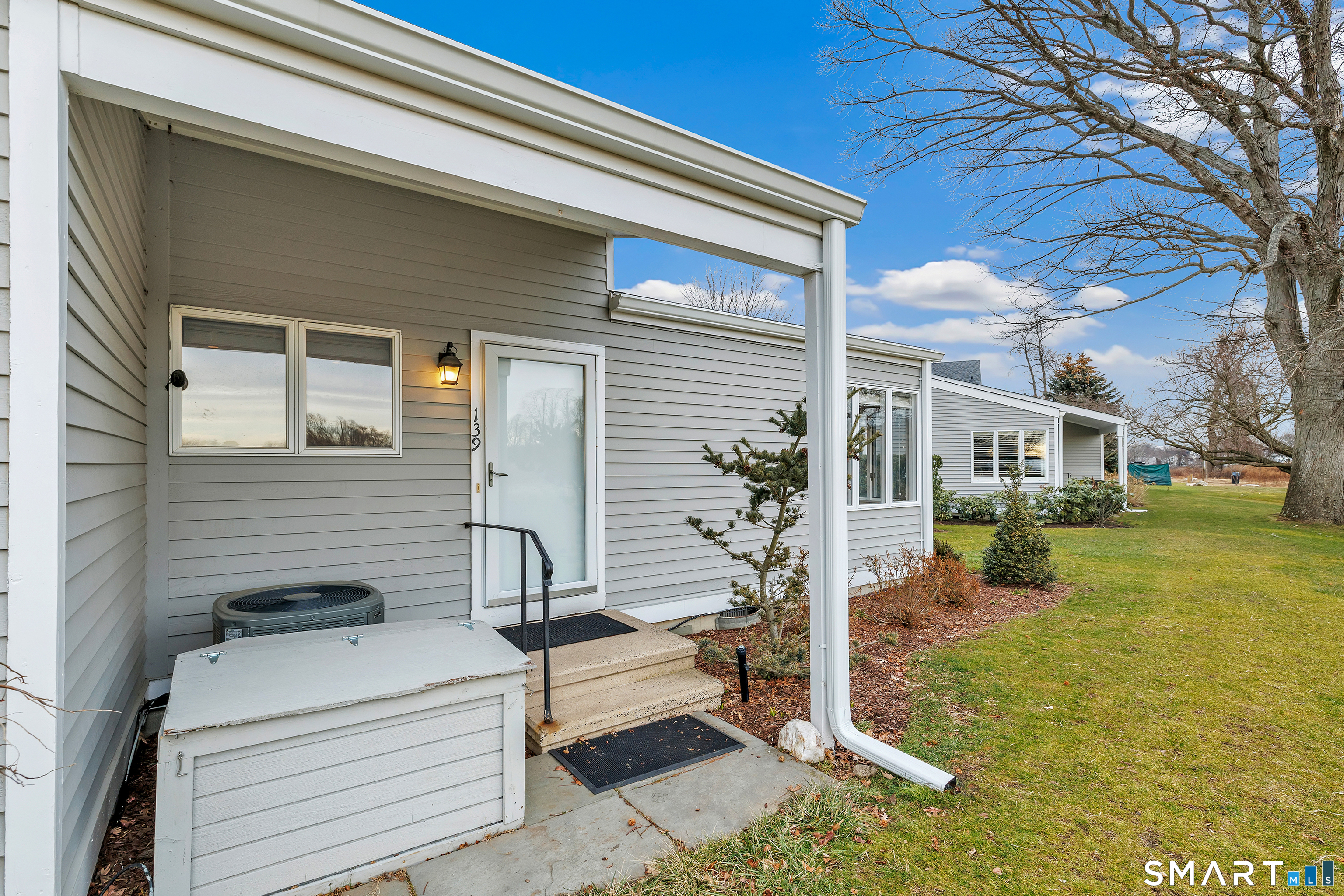 139 Field Point Drive, Unit 139 Fairfield, CT 06824 - Photo 34 of 34 a view of a house with a yard