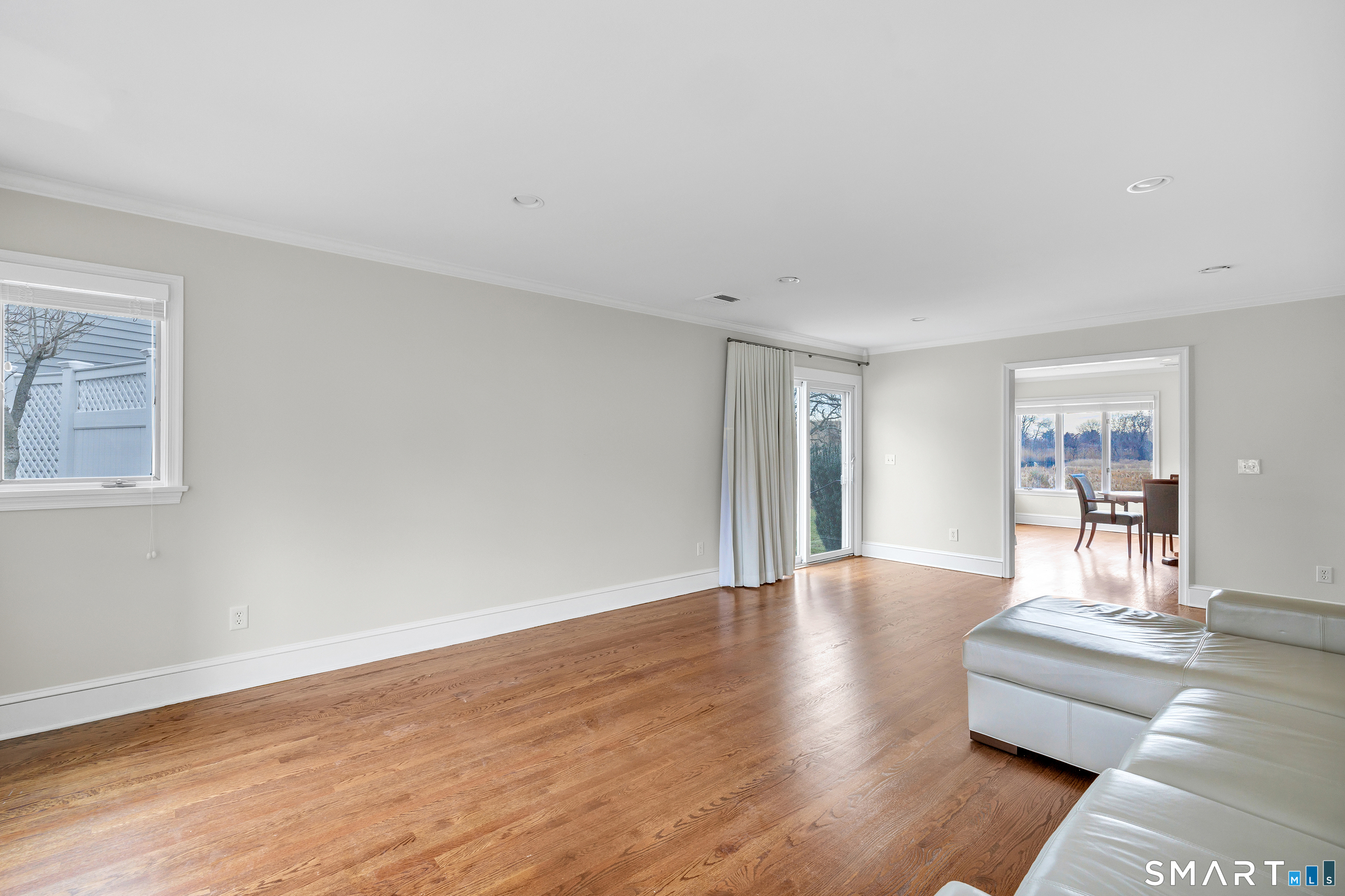 139 Field Point Drive, Unit 139 Fairfield, CT 06824 - Photo 8 of 34 a living room with furniture and wooden floor