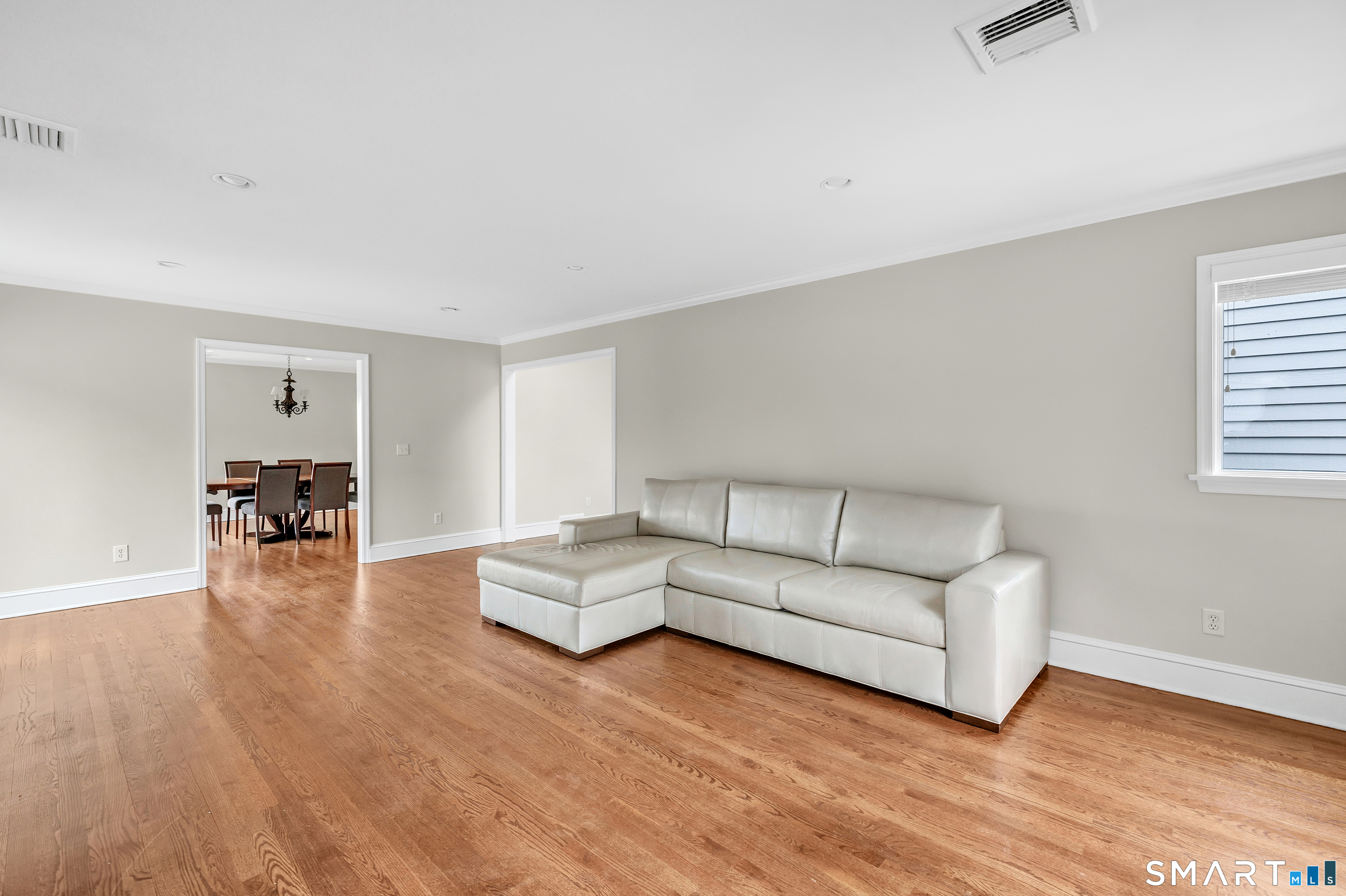 139 Field Point Drive, Unit 139 Fairfield, CT 06824 - Photo 9 of 34 a living room with furniture and a wooden floor