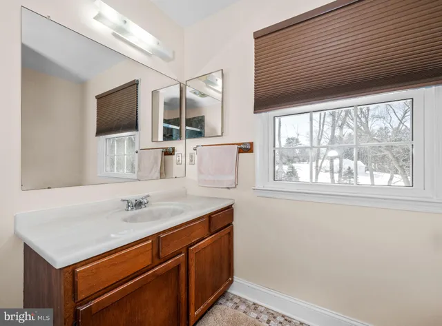 a bedroom with a bed a dresser and flat screen tv