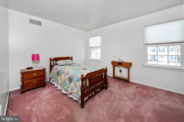 a bedroom with a bed and hallway