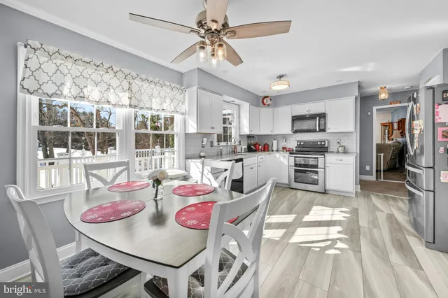 a kitchen with stainless steel appliances kitchen island granite countertop a stove a sink and a refrigerator