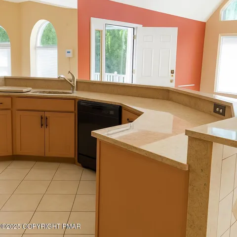 a kitchen with a sink cabinets and a window