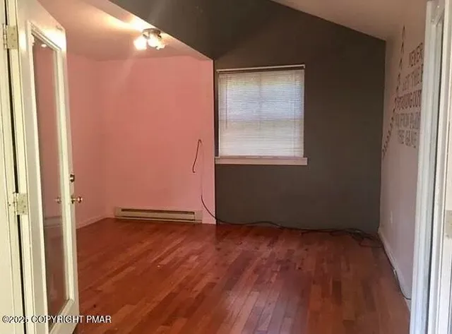 a living room with furniture and large windows