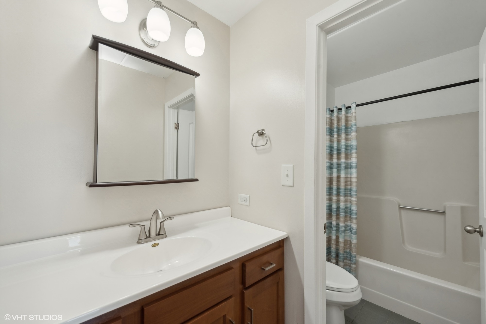 1605 Kenneth Circle, Unit 1605 Elgin, IL 60120 - Photo 7 of 12 a bathroom with a sink vanity granite toilet and shower
