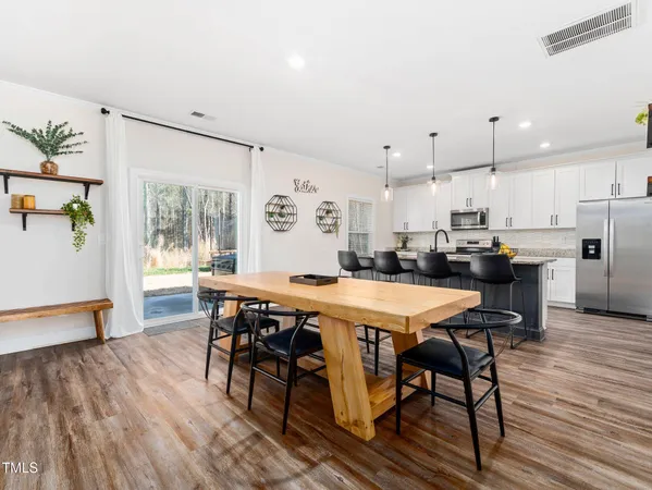 a view of a dining room with furniture and wooden floor