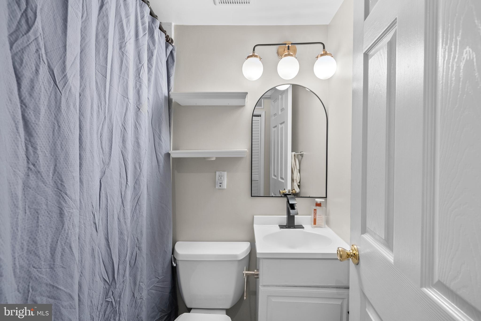 718 Park Road Northwest, Unit 1 Washington, DC 20010 - Photo 20 of 28 a bathroom with a toilet sink and mirror