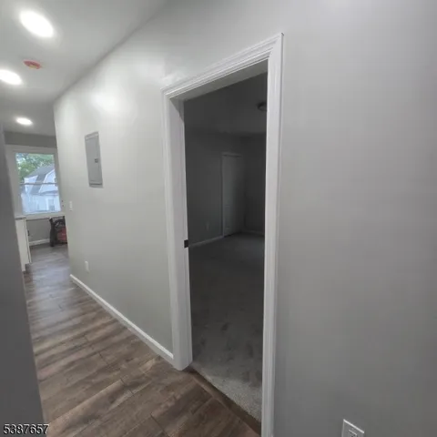 a view of hallway with wooden floor