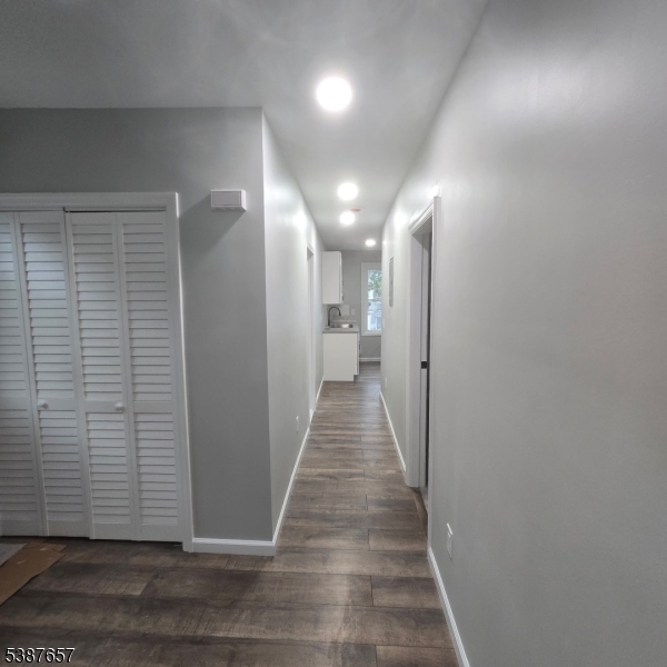 16 Baldwin Avenue, Unit 3 Newark, NJ 07108 - Photo 4 of 8 a view of a hallway with wooden floor