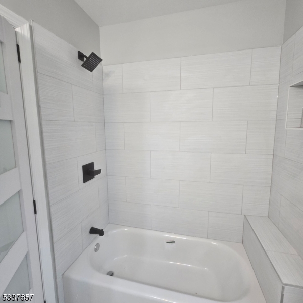 16 Baldwin Avenue, Unit 3 Newark, NJ 07108 - Photo 7 of 8 a bathroom with a bathtub