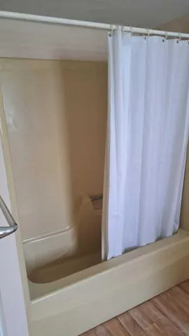 a kitchen with granite countertop white cabinets white appliances a sink and a window