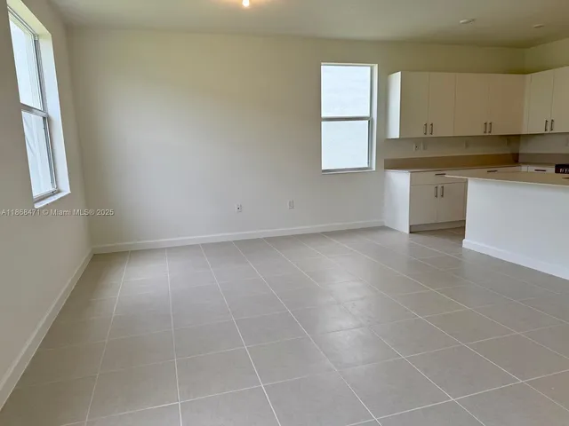 an empty room with windows and entrance