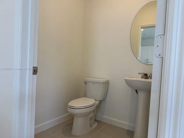 a white toilet sitting next to a shower