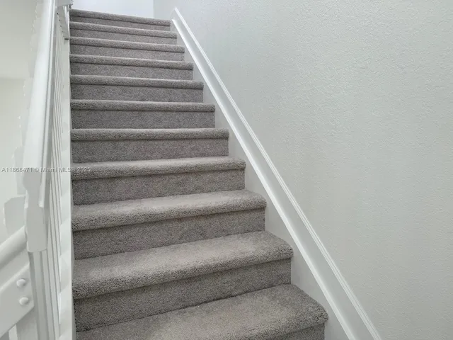 a view of staircase with white walls